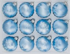 twelve blue glass christmas ornaments in a box