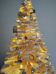 a wooden christmas tree with lights on it