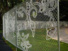 a fence with intricate white lace on it