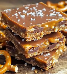 chocolate caramel pretzel bars stacked on top of each other with graham crackers