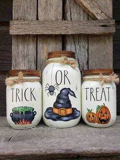 three painted mason jars with witches and pumpkins on them, one for trick or treat