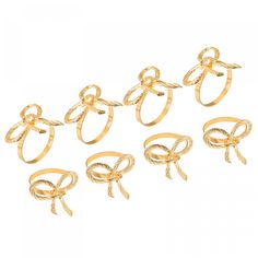 six gold rings with bows on each one, all in different shapes and sizes are shown