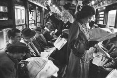 black and white photos of people sitting on a train, one woman reading a newspaper while the other looks at her cell phone