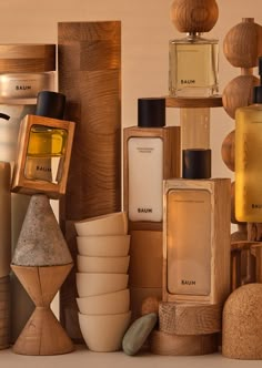 many different types of perfumes are stacked on top of each other