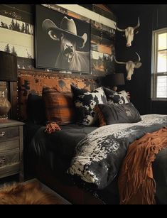 a bed room with a neatly made bed and cow heads on the wall above it