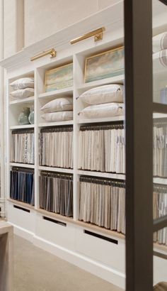 the shelves are filled with many different types of fabric