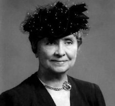 an old black and white photo of a woman wearing a hat with feathers on it