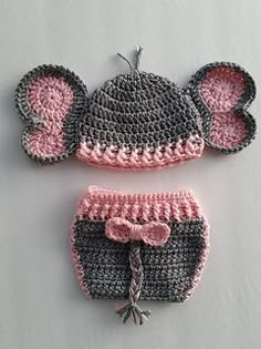 two crocheted hats and diaper covers with ears on the top one has a pink bow