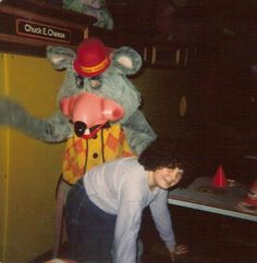 a man standing next to a large stuffed animal