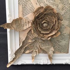 an old book page with a flower made out of it's pages in the shape of a rose