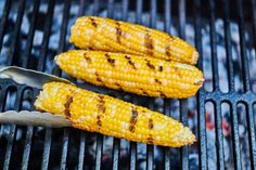 grilled corn on the cob with tongs