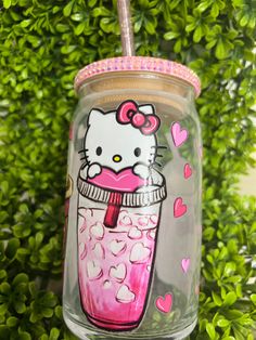 a hello kitty drink in a mason jar with pink hearts on the rim and lid