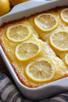 a dish filled with lemons on top of a table