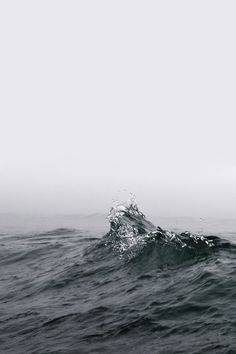 the water is very choppy in this black and white photo, it looks like something from another planet