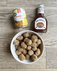 a white bowl filled with meatballs next to a can of pineapple chip sauce