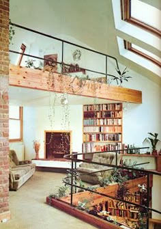 a living room filled with furniture and lots of books