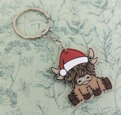 a keychain with a cartoon character wearing a santa's hat on it