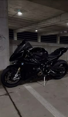 a black motorcycle parked in a parking garage