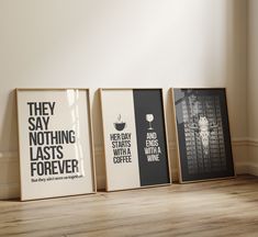 three framed posters sitting on top of a wooden floor