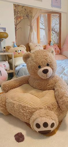 a large teddy bear sitting on top of a bed in a child's room