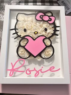 a hello kitty cake in a box with the word rosie written on it