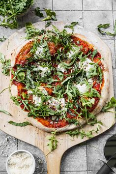 a pizza sitting on top of a wooden cutting board