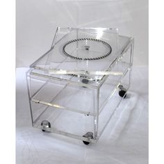 an acrylic box with wheels is shown on a white background