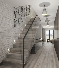 a white brick wall with stairs and pictures on the wall