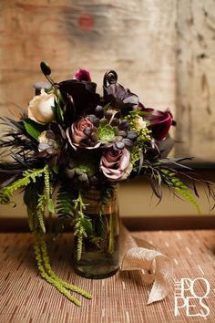 a vase filled with flowers on top of a wooden table