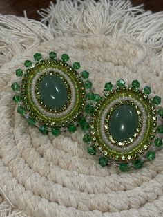 THESE ARE DISCOUNTED DUE TO A BEAD MEND THAT WAS DONE IN THE EDGING OF ONE OF THE EARRINGS. Hand made various shades of green,  and gold lined green rhinestones beaded stud earrings with green aventurine center. Sewn using nylon white thread. Faux leather backing. Earring peg is stainless steel. These were hand crafted by me. All stones and seed beads are not uniform, which gives the overall product a more authentic and "natural" touch. <3 Beaded Earrings Green, Green Beaded Earrings, Beaded Stud Earrings, Earring Inspo, Native Crafts, Nativity Crafts, Bead Work Jewelry, Beading Projects, Earrings Green