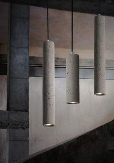 three concrete lights hanging from the ceiling