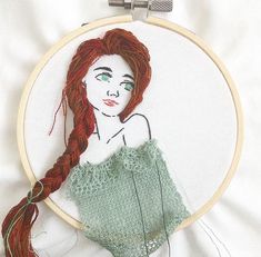 a woman with red hair and green eyes is depicted in a hand embroidery pattern on a white background