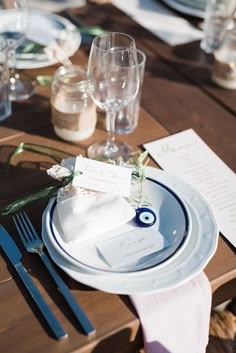 the table is set with place cards and silverware