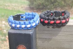 two bracelets sitting on top of a wooden post