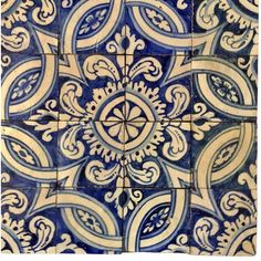 a blue and white tile with an intricate design