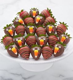 chocolate covered strawberries decorated like turkeys and topped with strawberries in the shape of birds