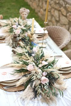 the table is set with plates and place settings