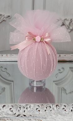 a pink vase sitting on top of a table