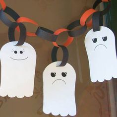 three ghost decorations hanging from a string