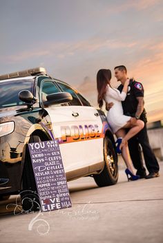 a police car parked next to a couple