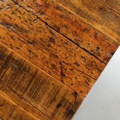 an old wooden floor with peeling paint on the top and bottom part of it's surface