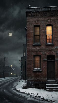 an old brick building sitting on the side of a road under a dark sky filled with clouds