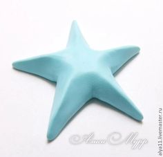 a blue star shaped object sitting on top of a white table