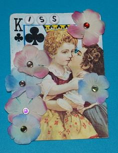 a card with some flowers on it and two women kissing each other in front of a blue background