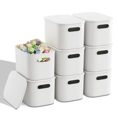 several white storage containers stacked on top of each other