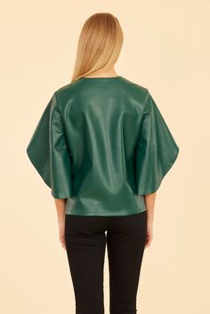 Our Faux Leather Cascade Sleeve Top is sure to be a striking addition to your autumn wardrobe. This versatile and stylish blouse features dramatic cascade sleeves that flow beautifully, adding movement and flair to your look. The sleek faux leather finish offers a modern edge, making it the perfect piece to complete your chic seasonal outfits. Faux leather Cascading sleeves V-neck Available in Black, Dark Pink, and Green Dry clean Style: 75634 Seasonal Outfits, Cape Designs, Fur Top, Linen Gauze, Midi Dress Formal, Autumn Wardrobe, Iconic Dresses, Leather Finish, Cape Sleeves