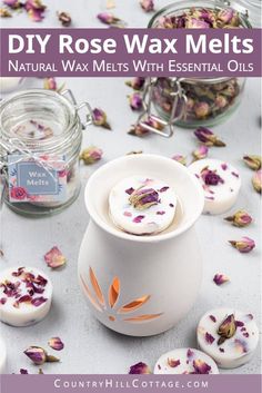 a white vase sitting on top of a table filled with dried flowers and candles next to jars