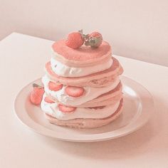 a stack of strawberry shortcakes sitting on top of a white plate