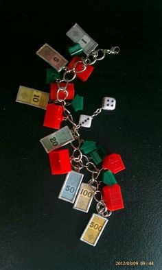 a lego key chain with dices and blocks attached to it, on a black surface