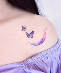 a woman's chest with two butterflies on it and the moon in the sky